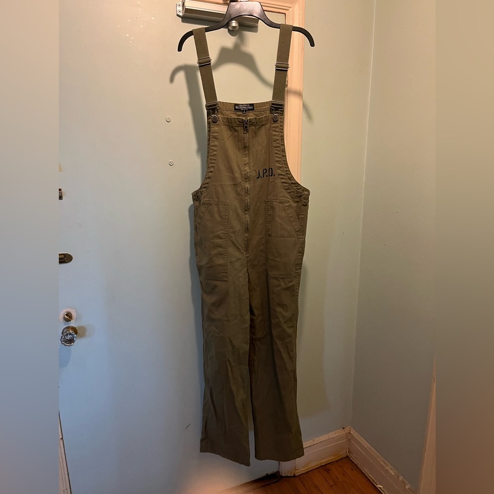 J. Peterman Company olive green cotton twill bib overalls.